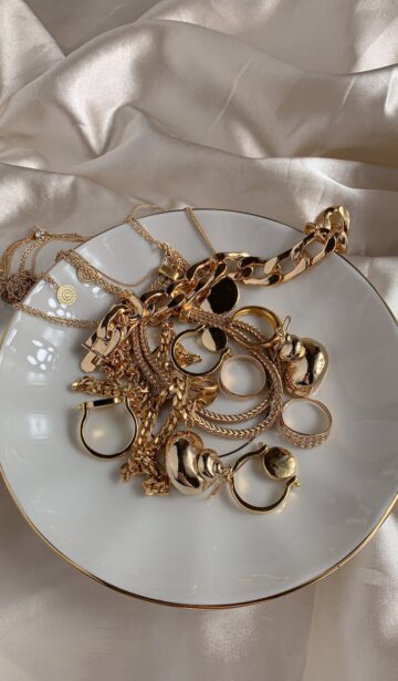 golden accessories on white saucer