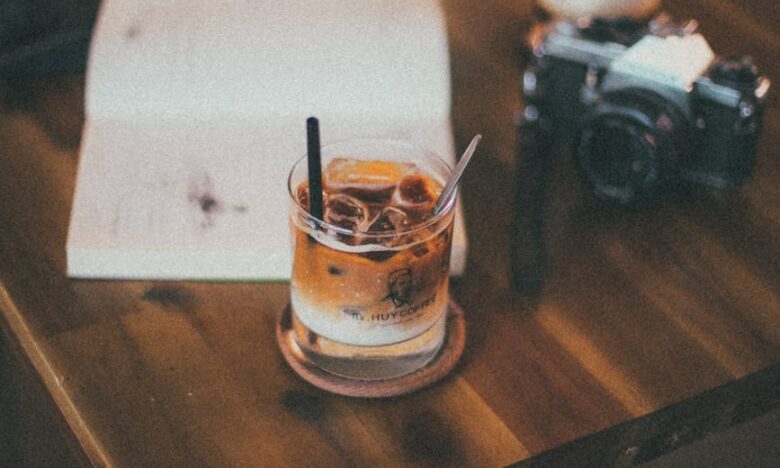 black bridge camera near drinking glass