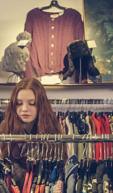 photo of woman near clothes